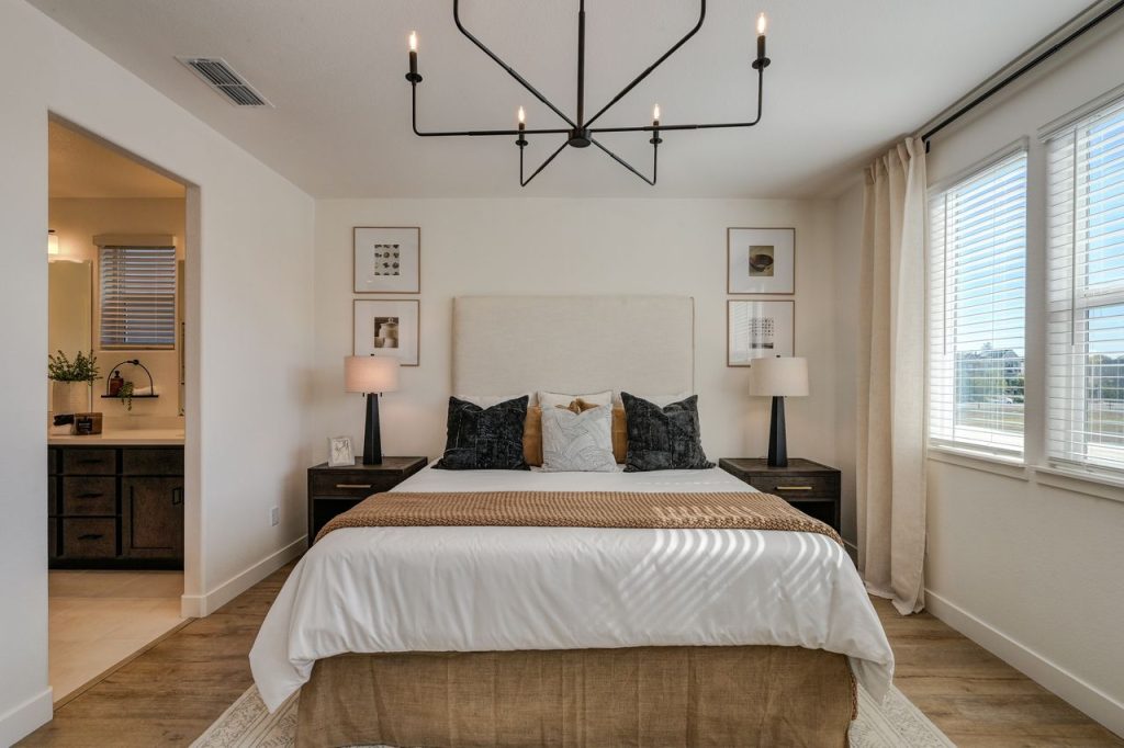 A stylish bedroom with contemporary decor and natural lighting.